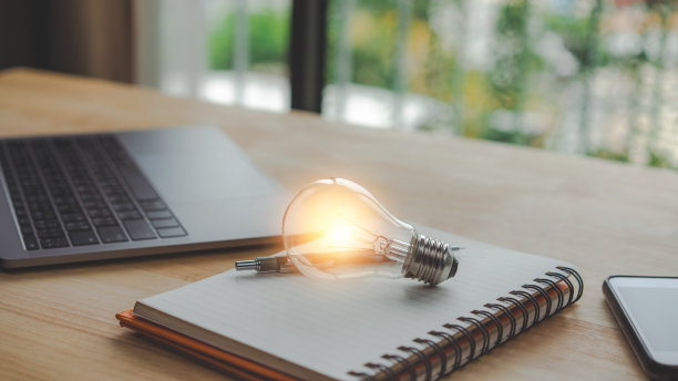 书本上明亮的灯泡。具有创新和灵感的理念。图片下载