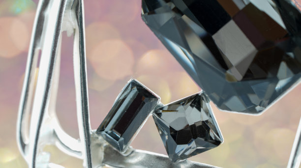 明亮的切割绿色钻石拍摄在工作室与彩色背景图片下载