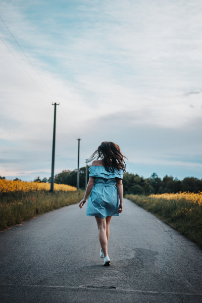 年轻的20-24岁的身材苗条的黑发女孩，穿着浅蓝色的夏装，随着音乐的节奏翩翩起舞。一个真正的普通人享受运动和舞蹈的真实写照。知道自己图片下载
