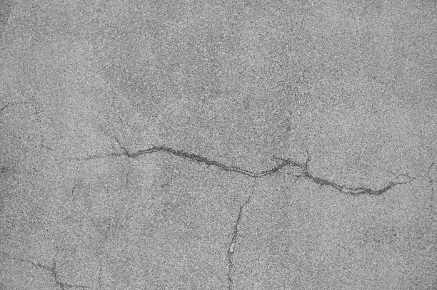 工业建筑中带有裂缝的垃圾混凝土水泥墙的特写，非常适合你的设计和纹理背景。图片下载