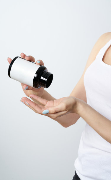 女人手拖拽或医药瓶在白色背景图片下载