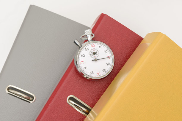 天文钟上的灰色和黄色办公文件夹。图片下载