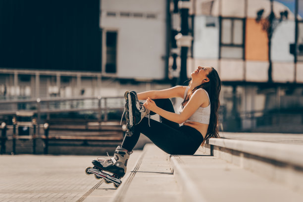 微笑的金发美女在散步道上滑冰图片下载