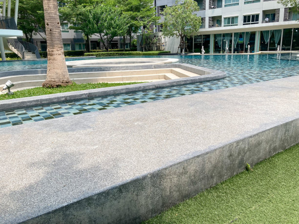 酒店里的一个长水池，中间有一棵树。图片下载