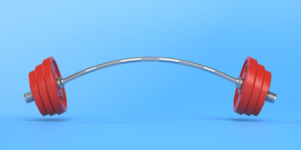金属杠铃弯曲的两边，因为非常重的重量添加在蓝色的背景上图片下载