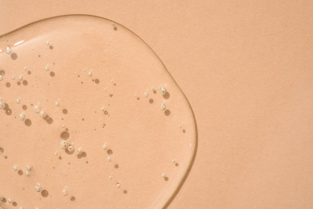 滴透明化妆品纹理凝胶米色背景与气泡。副本的空间。沐浴露的背景图片下载