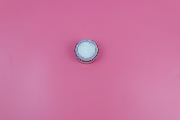 淡粉色背景的面霜。俯视图图片下载