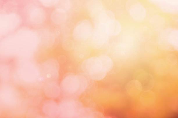 摘要模糊橘色和桃色为背景，模糊户外节日灯光和粉红色泡泡焦点纹理装饰。图片下载