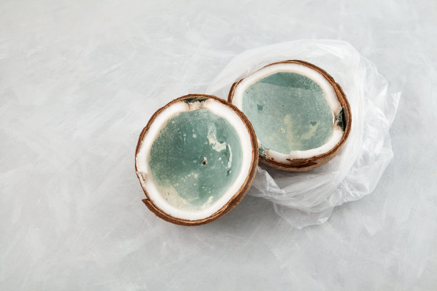 发霉变质的椰子装在塑料袋里，表面浅灰色。不适当的储存食物。减少有机废物图片下载