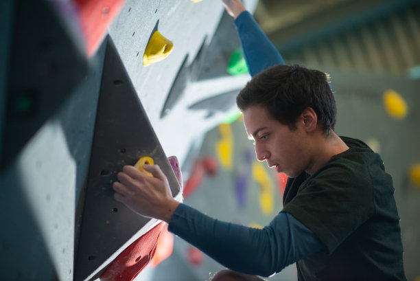 年轻运动员抱石的侧视图图片下载