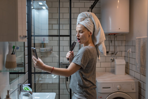 沐浴后对着镜子唱歌的快乐女人图片下载