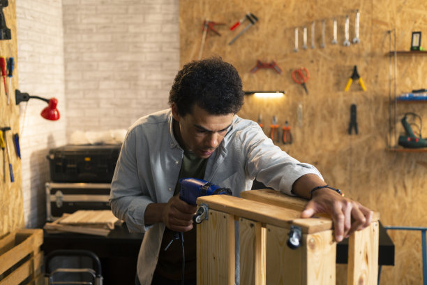 木工在车间用钻头工作图片下载