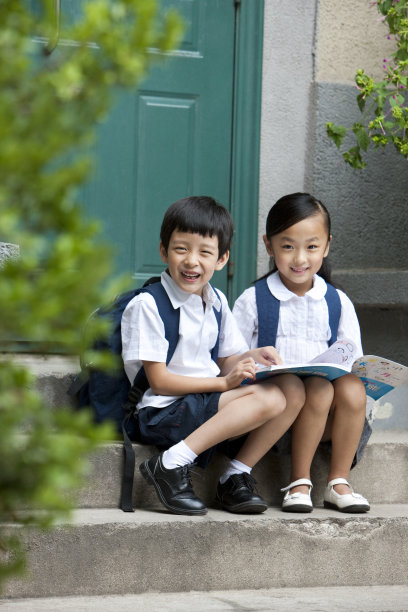 儿童坐在普通社区门口台阶上图片下载