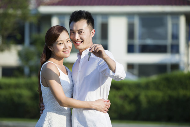 年轻情侣展示新房的钥匙图片下载