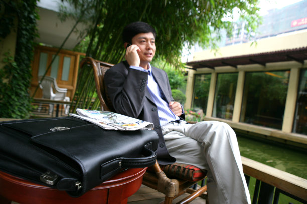商务人士在酒店阳台打电话图片下载