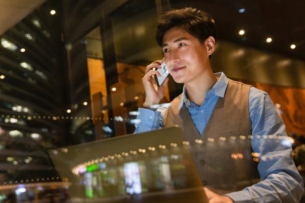 商务男士边用电脑边打电话图片下载