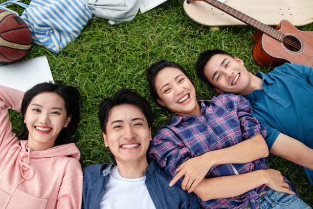 快乐的大学生躺在草地上图片下载