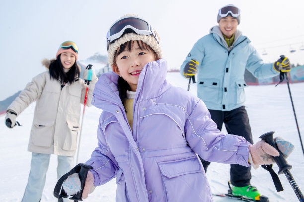滑雪场上和女儿一起滑雪的一家三口图片下载