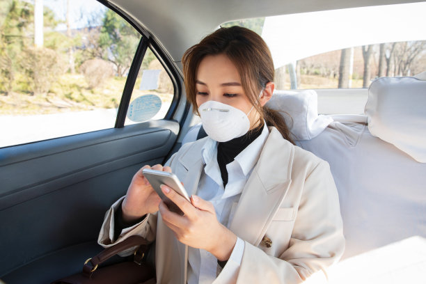 年轻女人戴口罩乘坐汽车图片下载