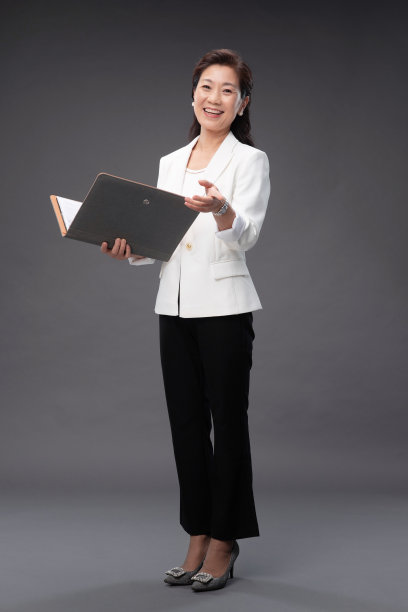 拿着户型图册做手势的优雅商务女士图片下载
