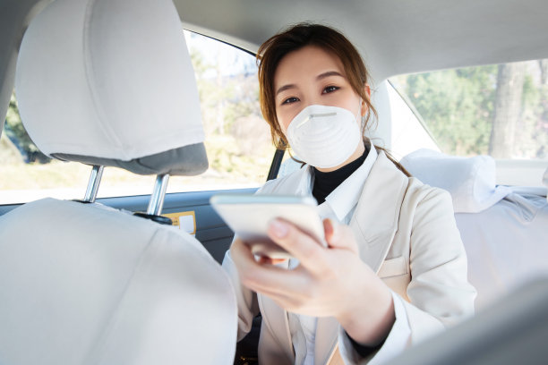 年轻女人戴口罩乘坐汽车图片下载