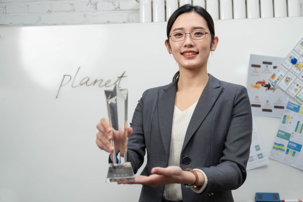 成功的商务女士拿着奖杯图片下载