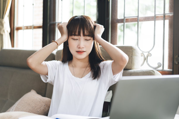 亚洲少女按摩头试着从使用电脑一天。图片下载