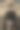 正面照片是一个穿着黑色衣服的年轻男性模特，在一幢建筑后面摆姿势，留着现代发型。图片下载