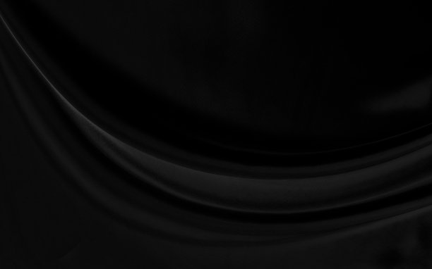 黑灰色缎子深色面料质感奢华闪亮，是抽象的丝绸布料背景上的图案柔和波浪模糊美丽。图片下载