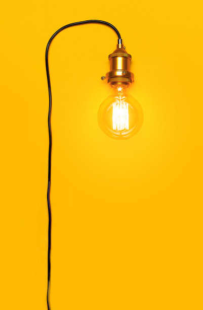 复古时尚的爱迪生灯亮黄色背景。俯视图平面复制空间。创意概念，设计师灯，现代室内项目。照明、电、背景配灯图片下载