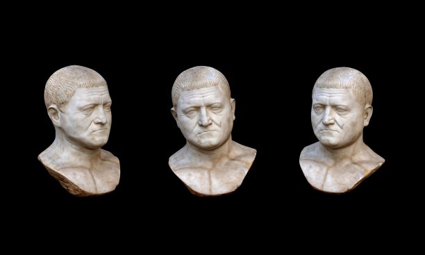 三个石膏复制的古罗马头像孤立在黑色的背景上。大理石雕刻人的脸。图片下载