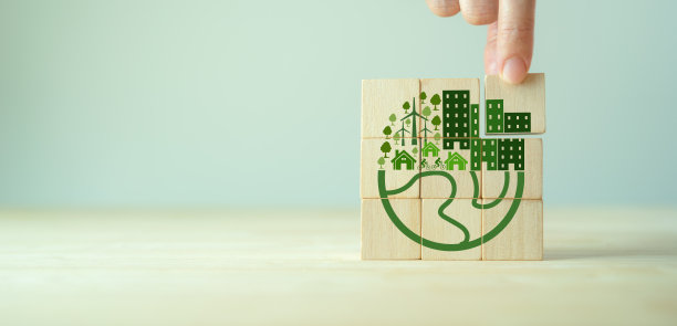 环保、绿色的企业文化理念。碳中和和净零目标。可持续的环境和商业。建立绿色社区。手握灰色背景上的生态地球仪木制立方体。图片下载