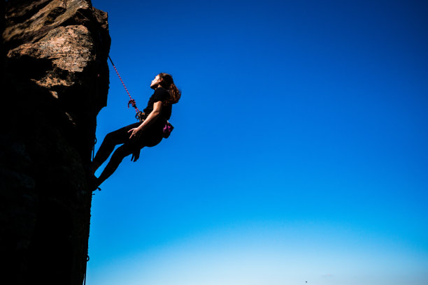 爬上悬崖的攀岩者图片下载
