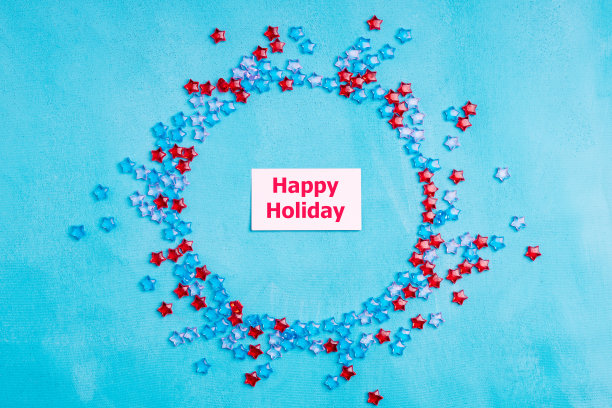 快乐的节日写在白纸上，白纸周围是塑料星星图片下载