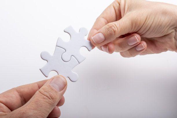 两个匹配的白色拼图手握图片下载