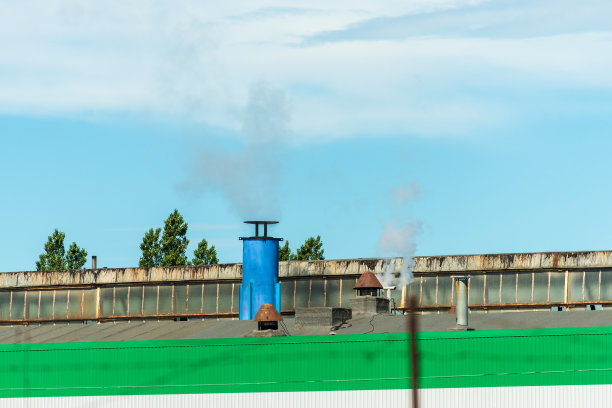 工厂的烟囱在车间的屋顶上图片下载