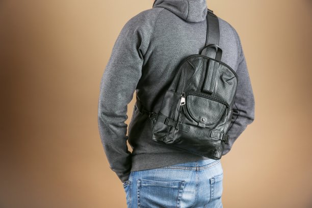 男子穿着休闲服装与皮革双肩包工作室照片拍摄图片下载