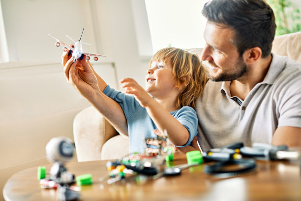 孩子儿子父亲家庭快乐玩孩子童年爸爸爱乐趣微笑小男人家玩具飞机旅行假期飞机假期图片下载