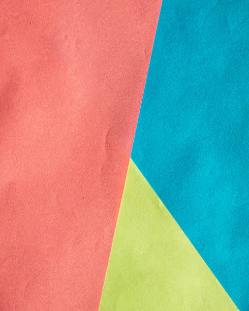多色背景的几张纸。背景是彩色纸做成的。背景，设计和横幅的彩色床单。三色几何背景——红色、蓝色、黄色图片下载
