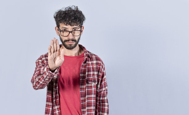 严肃的年轻人用手掌示意，白种人用手示意，用手示意图片下载