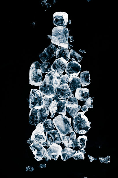 一个冰凉纯净的饮料瓶的概念。瓶子形状，由黑色冰面上的天然冰块制成。图片下载