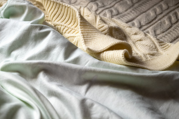 针织毛毯覆盖床上关闭纺织品背景图片下载