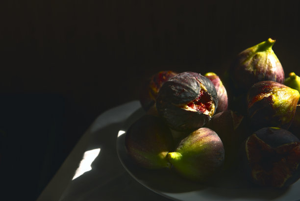 新鲜的无花果。这张照片很低调。阳光照射在桌子上成熟的无花果上。成熟芬芳的无花果，半开着。复制空间，特写，软选择焦点。紫色的阴影。艺术的观点图片下载