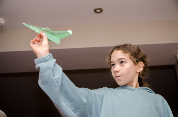 小女孩扔纸飞机图片下载
