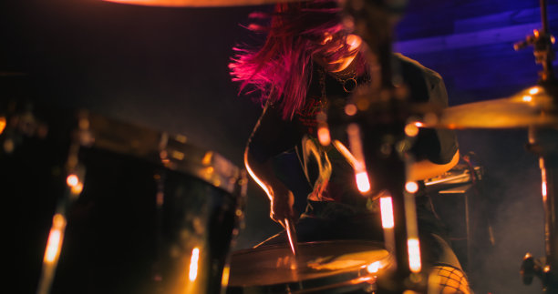 红头发的专业鼓手女孩在夜总会的舞台上表演图片下载