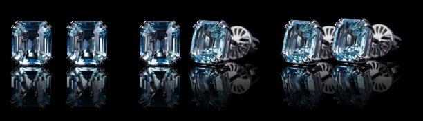 美丽的金耳环与海蓝宝石在黑色的背景图片下载