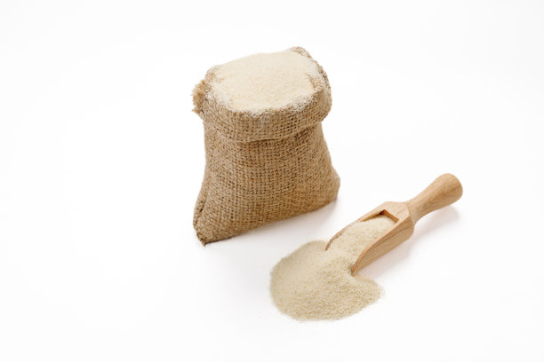 在白色的背景下，碗和袋子里的粗面粉被孤立起来。高质量的照片图片下载