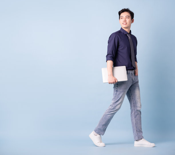 蓝色背景的年轻亚洲商人的全长形象图片下载