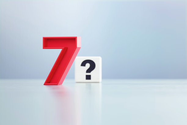 红色7号和问号写的白方坐在离焦背景前图片下载