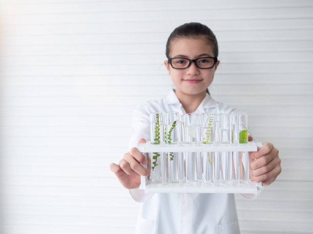 有选择性的重点。年轻的科学家亚洲女孩在实验室里展示试管。实验室，科学实验，研究理念。图片下载